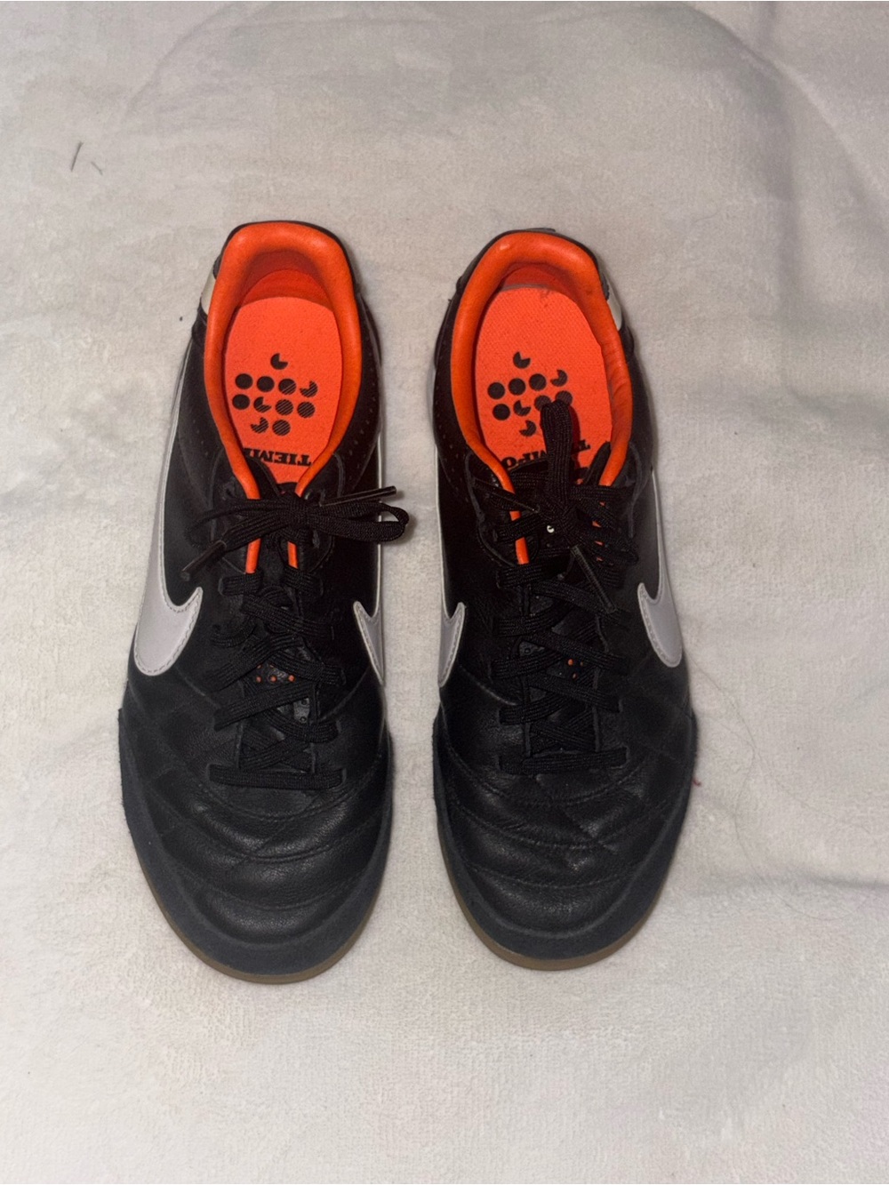 Nike Tiempo Black Indoor Soccer Shoes with Orange Lining and White Swoosh